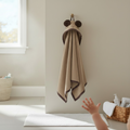 hooded bath towel hanging on a wall 