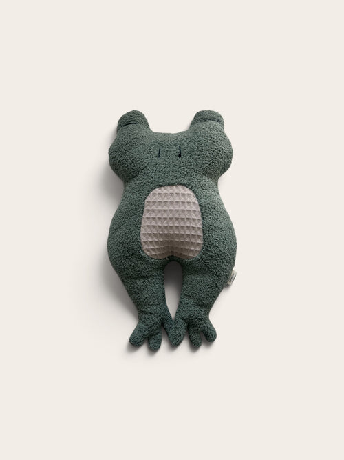 A dark green plush frog toy with a textured light beige belly, photographed against a solid off-white background.
