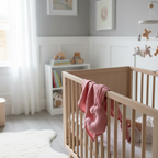 Muslin baby comforter blanket in rose pink in nursery setting
