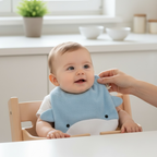 Baby wearing blue cotton towelling bib during feeding absorbent newborn baby bib high chair mealtime