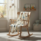 Bear print muslin baby blanket made from bamboo cotton draped over a wooden rocking chair in a nursery.