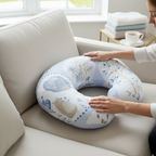 Blue nursing pillow for breastfeeding and baby support on sofa with soft fabric detail