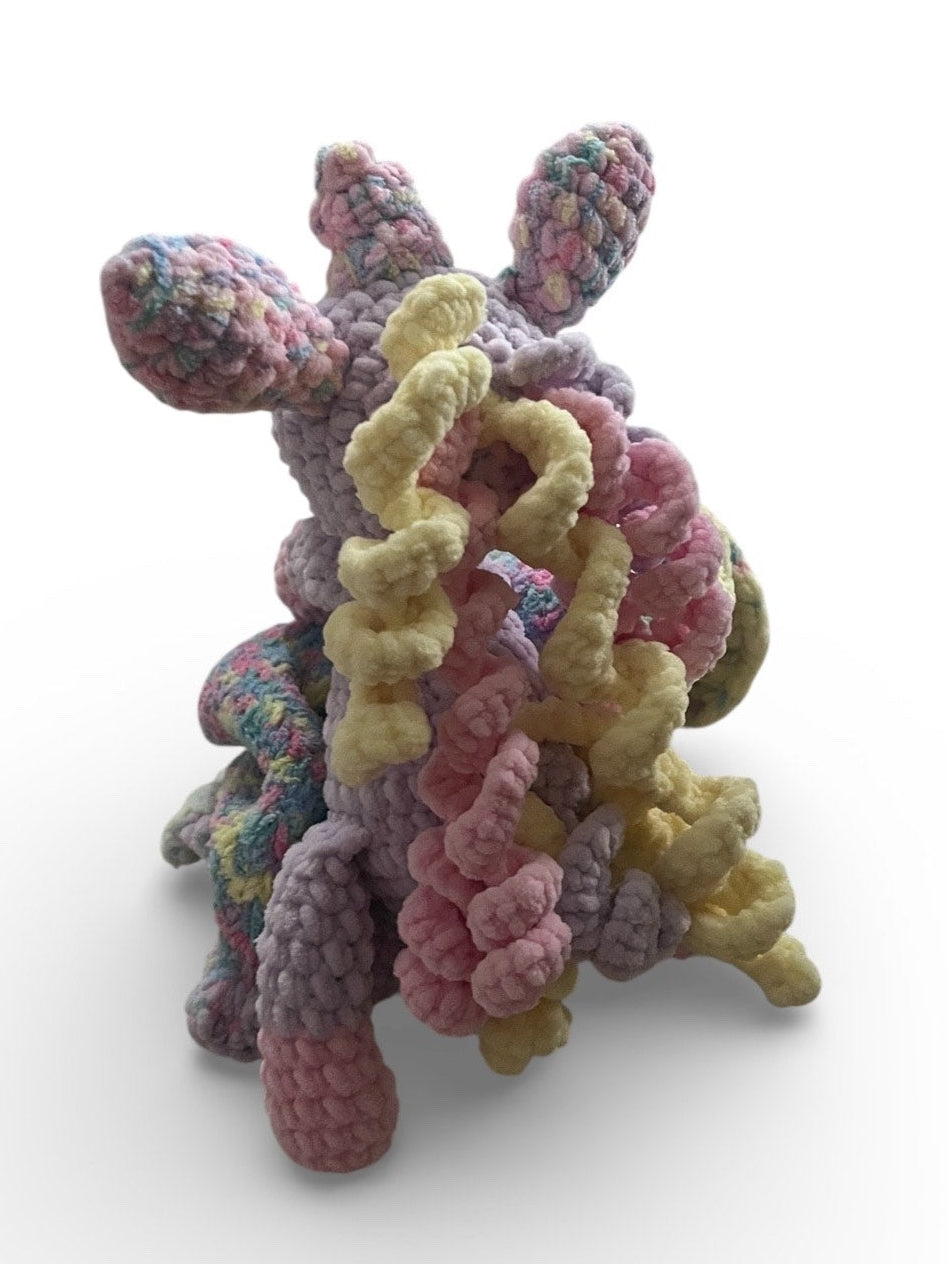 Back view of crochet unicorn baby comforter showing textured blanket and handmade details